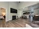 Stylish living room with a fireplace, flat screen tv and seamless access to the dining area and kitchen at 8524 Loxton Cir, Charlotte, NC 28214