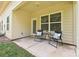 Cozy outdoor patio seating with table and chairs and a view of the green lawn at 8524 Loxton Cir, Charlotte, NC 28214