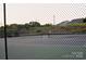 Community tennis court with green fencing, offering a great space for sports and recreation at 8524 Loxton Cir, Charlotte, NC 28214