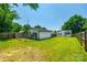 Spacious backyard featuring a detached garage, fire pit, and chain link/wood fence at 903 Rhode Island Ave, Kannapolis, NC 28083