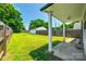Expansive backyard with lush green grass, a wooden fence, detached garage and patio area at 903 Rhode Island Ave, Kannapolis, NC 28083