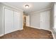 Bedroom featuring neutral walls, hardwood floors, closet, and connecting door to another room at 903 Rhode Island Ave, Kannapolis, NC 28083