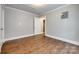 Neutral bedroom featuring hardwood floors, neutral walls, and a connecting door to another room at 903 Rhode Island Ave, Kannapolis, NC 28083