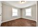 A light-filled bedroom with hardwood floors, complemented by dual windows offering ample natural light at 903 Rhode Island Ave, Kannapolis, NC 28083