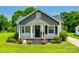 Charming home features a gray roof, flower beds, and a cozy porch with a seating area at 903 Rhode Island Ave, Kannapolis, NC 28083
