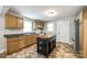 Traditional kitchen with wooden cabinets, black countertops, a movable island, and stainless steel refrigerator at 903 Rhode Island Ave, Kannapolis, NC 28083