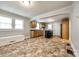 Open-concept kitchen with oak cabinets, black appliances, and lots of natural light at 903 Rhode Island Ave, Kannapolis, NC 28083