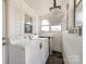 Bright laundry room featuring a washer, dryer, ample lighting and storage for laundry accessories at 903 Rhode Island Ave, Kannapolis, NC 28083