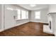 Bright living room featuring a fireplace, large windows with white trim, and newer hard wood floors at 903 Rhode Island Ave, Kannapolis, NC 28083