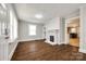 Bright living room featuring a decorative fireplace, built-in shelves, and newer hard wood floors at 903 Rhode Island Ave, Kannapolis, NC 28083