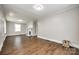 Spacious living room featuring a decorative fireplace, large windows with white trim, and newer hard wood floors at 903 Rhode Island Ave, Kannapolis, NC 28083