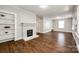Spacious living room featuring a decorative fireplace, built-in shelves, and newer hard wood floors at 903 Rhode Island Ave, Kannapolis, NC 28083