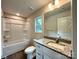 Bathroom featuring granite countertops, a bathtub with shower, and modern fixtures at 907 W Georgia Ave, Bessemer City, NC 28016