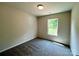 Neutral bedroom with plush carpeting and a window that provides natural light and wooded views at 907 W Georgia Ave, Bessemer City, NC 28016