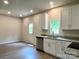 Well-lit kitchen featuring stainless steel appliances, granite countertops, and white cabinetry at 907 W Georgia Ave, Bessemer City, NC 28016