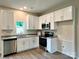 Modern kitchen with white cabinets, stainless steel appliances, and granite countertops at 907 W Georgia Ave, Bessemer City, NC 28016