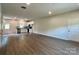 Bright open-concept space with hardwood flooring connecting the living area to the kitchen at 907 W Georgia Ave, Bessemer City, NC 28016