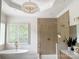 Elegant bathroom featuring a shower, a free-standing tub, and a stylish chandelier for a spa-like ambiance at 9604 Oliver Ct, Harrisburg, NC 28075