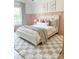 Stylish bedroom boasts soft pink walls, modern decor, and plush bedding for a relaxing and inviting atmosphere at 9604 Oliver Ct, Harrisburg, NC 28075