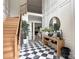 Elegant foyer showcasing a staircase, checkered floor, decor, and inviting entrance at 9604 Oliver Ct, Harrisburg, NC 28075