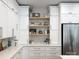 Kitchen showcasing white cabinets, open shelving, and stainless steel appliances, perfect for cooking at 9604 Oliver Ct, Harrisburg, NC 28075