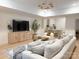 Cozy living room features a spacious sectional sofa, modern lighting, and a kitchen view, perfect for relaxation and entertaining at 9604 Oliver Ct, Harrisburg, NC 28075
