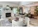 Inviting living room featuring a fireplace, stylish furniture, and natural light, seamlessly connected to the dining area at 9604 Oliver Ct, Harrisburg, NC 28075