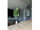Bonus room featuring a large TV, stylish decor, and natural light, creating a cozy and modern living space at 9604 Oliver Ct, Harrisburg, NC 28075