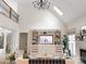 Bright living room with vaulted ceilings, built-in shelves, and a stylish chandelier for a modern aesthetic at 9604 Oliver Ct, Harrisburg, NC 28075