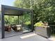 Enclosed patio with glass walls, cozy seating, and lush greenery, perfect for outdoor relaxation and entertaining at 9604 Oliver Ct, Harrisburg, NC 28075