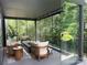 Enclosed patio featuring comfortable seating, glass walls, and a serene outdoor view, ideal for relaxing and entertaining at 9604 Oliver Ct, Harrisburg, NC 28075