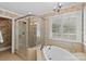 Elegant bathroom featuring a glass shower enclosure and soaking tub under a window with plantation shutters at 1019 Westlake Dr, Kannapolis, NC 28081