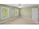 Neutral bedroom with ceiling fan and two windows providing natural light at 1019 Westlake Dr, Kannapolis, NC 28081