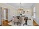 Elegant dining room with stylish lighting, hardwood floors, wainscoting and ample seating at 1019 Westlake Dr, Kannapolis, NC 28081