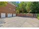 Side view of brick home featuring a three-car garage and backyard access at 1019 Westlake Dr, Kannapolis, NC 28081