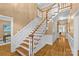 Elegant foyer with hardwood floors, a staircase with wood and white trim, and detailed wainscoting at 1019 Westlake Dr, Kannapolis, NC 28081