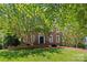 Traditional brick home with a well-manicured lawn and mature shade trees at 1019 Westlake Dr, Kannapolis, NC 28081