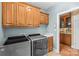 Well-organized laundry room featuring modern washer/dryer, sink, and ample cabinet storage at 1019 Westlake Dr, Kannapolis, NC 28081