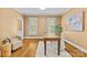 Bright office space with hardwood flooring, neutral paint, two windows, and a modern desk at 1019 Westlake Dr, Kannapolis, NC 28081