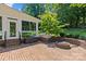 Brick patio with fire pit, seating, and access to the sunroom and rear yard at 1019 Westlake Dr, Kannapolis, NC 28081