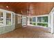 Spacious outdoor patio with brick flooring, wood ceiling, white trim and natural light at 1019 Westlake Dr, Kannapolis, NC 28081