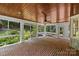 Enclosed sunroom with brick flooring, wood ceiling, and views of lush landscaping at 1019 Westlake Dr, Kannapolis, NC 28081