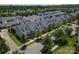 An aerial view of a neighborhood with sidewalks showcases well-maintained townhomes and street parking at 1027 Writers Way, Cornelius, NC 28031