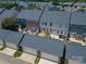 This home features an aerial view of fenced backyards, three garages, and tree-lined community at 1027 Writers Way, Cornelius, NC 28031