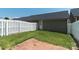Private fenced backyard boasts a well-maintained lawn and a brick patio at 1027 Writers Way, Cornelius, NC 28031