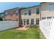 Charming brick townhome backyard with well-kept lawn and privacy fence at 1027 Writers Way, Cornelius, NC 28031