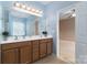 Well-lit en-suite bathroom with double vanity and access to primary bedroom at 1027 Writers Way, Cornelius, NC 28031