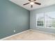 Inviting bedroom with plush carpet, a ceiling fan, and bright windows at 1027 Writers Way, Cornelius, NC 28031