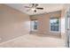 Neutral bedroom with carpet, fan and natural light from two windows at 1027 Writers Way, Cornelius, NC 28031