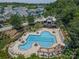 Aerial view of the neighborhood pool features a large pool, tables, chairs, and clubhouse at 1027 Writers Way, Cornelius, NC 28031